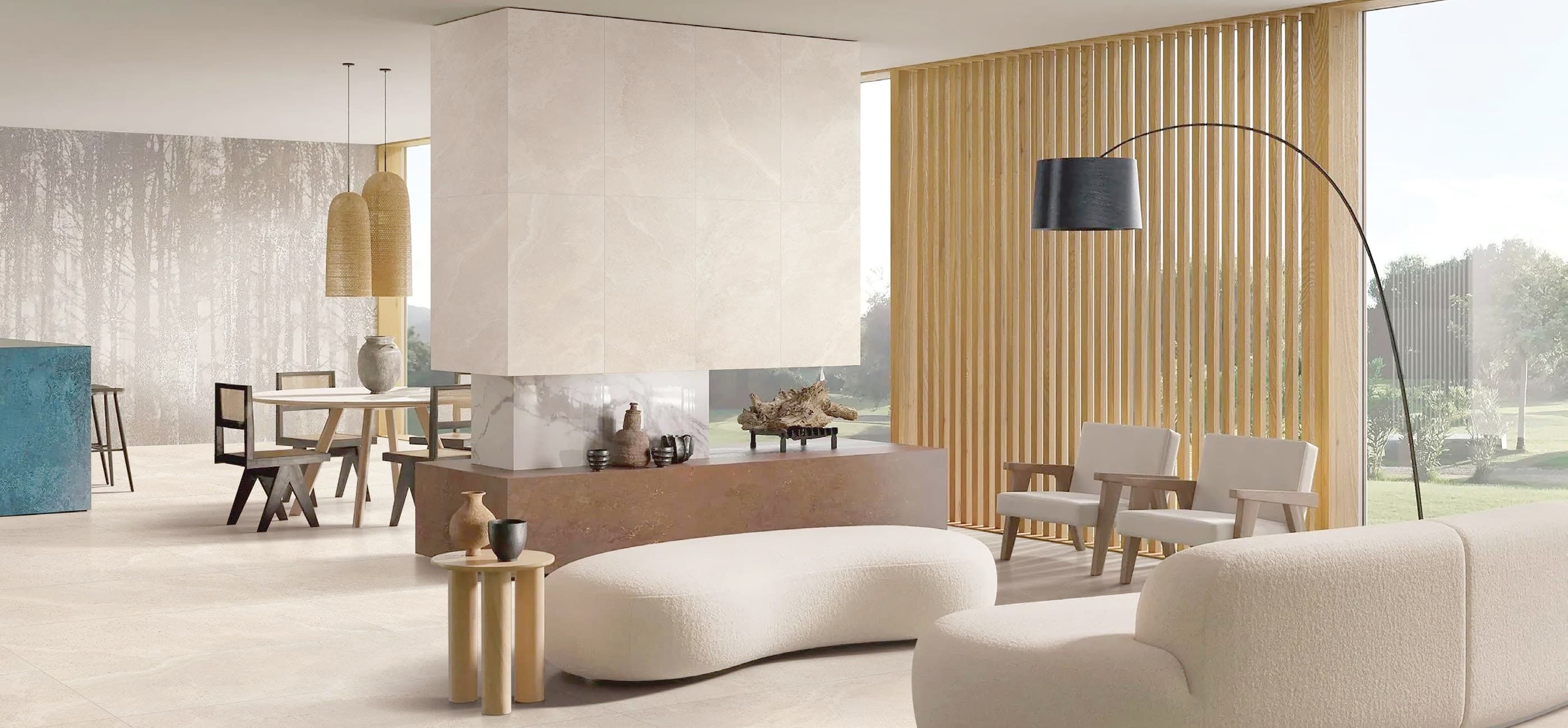 A contemporary living room finished in Padua porcelain, opening onto a garden